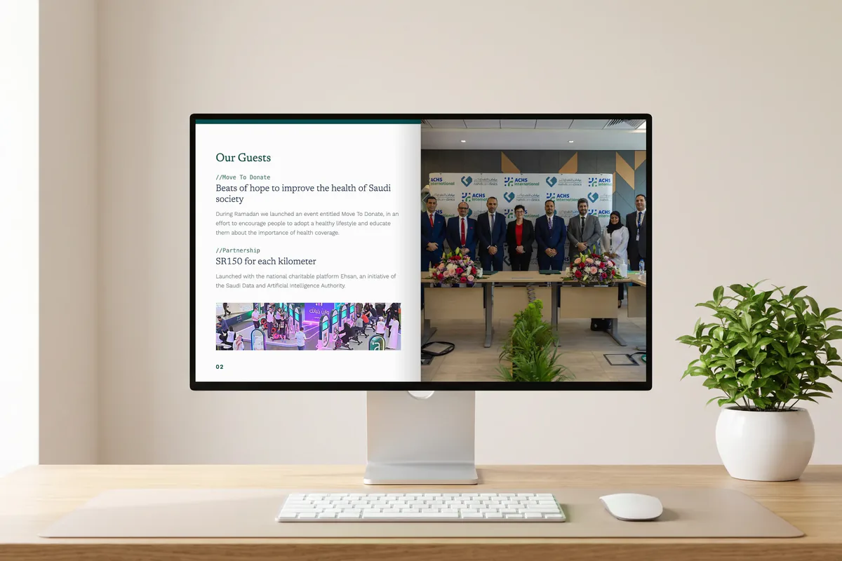 A desktop monitor showing the Our Guests page of the English Al Nahdi newsletter, beside a photo of the agreement signing with the Australian Council on Healthcare Standards